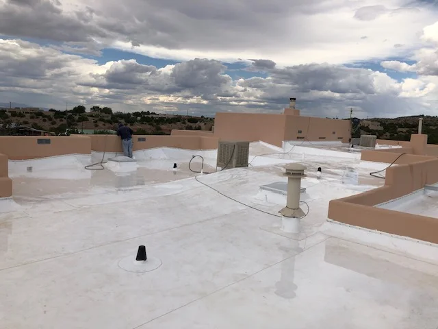 A roof covered with a white coating, reflecting sunlight and enhancing energy efficiency.